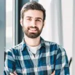 a man with beard and mustache wearing a blue and white flannel shirt