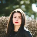 a woman with long hair wearing a black jacket